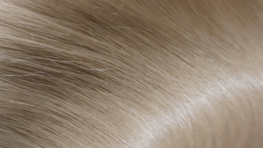 Flowing blonde hair being shake making waves slow motion