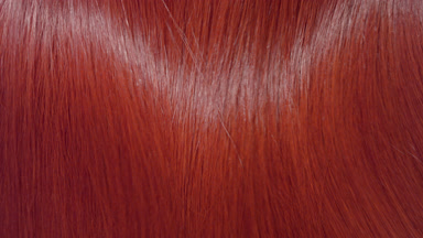 Glossy red dyed hair being shake making waves slow motion