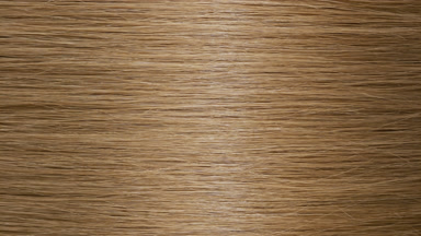 Light reflection passes through straight honey brown hair