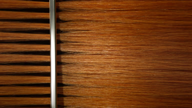 Silver comb combing ginger hair