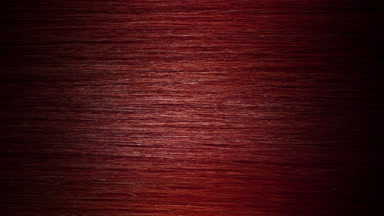 A stick running under red dyed hair surface making wave