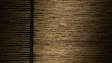 Honey brown hair being combed with plastic comb