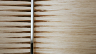 Silver comb combing blonde hair