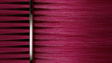 Silver comb combing pink dyed hair