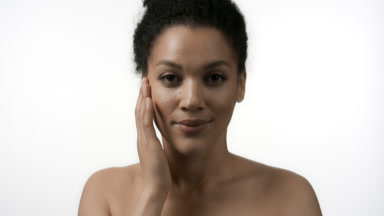 Water reflection of African American young woman strokes face