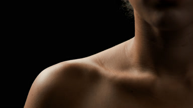 Fit African female model with dark curly hair moves her head up