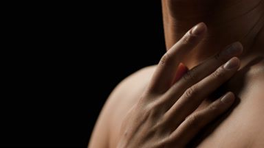 Gorgeous fit African woman moves head up and strokes clavicle