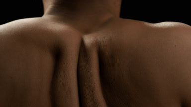 Good-looking African American female model moves her shoulders