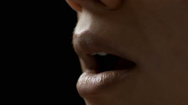 Young African American female model moves her lips