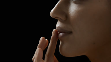 Young pretty African American woman strokes her lips