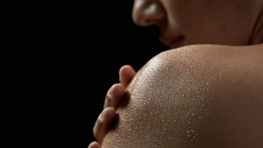 Pretty African American woman strokes her good-looking wet skin