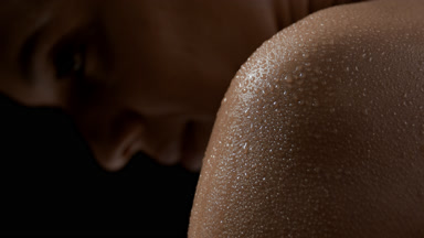 Young beautiful African woman with wet shoulder moves head up