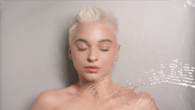Beautiful blond Caucasian woman with closed eyes under water