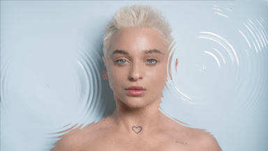 Beautiful young slim blond Caucasian woman turns to the camera