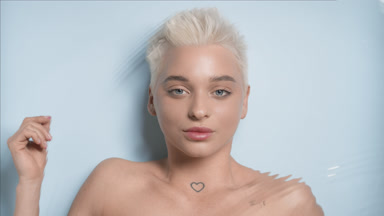 Caucasian woman with light hair strokes clavicles through water