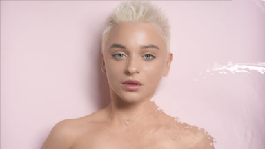 Gorgeous female model turns to the camera through rippling water