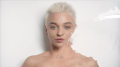 Underwater portrait of Caucasian woman turns head to the camera