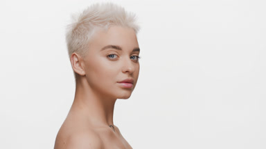 Beautiful young blond Caucasian woman turns head to the camera