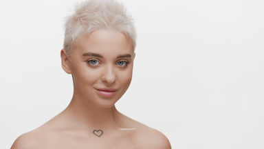 Gorgeous young slim Caucasian woman turns head to camera smiling