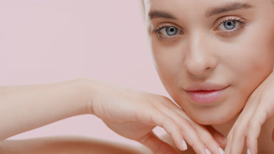 Gorgeous young slim light-haired Caucasian woman strokes face