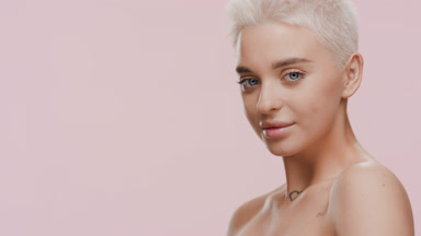 Gorgeous young Caucasian woman turns away from camera smiling