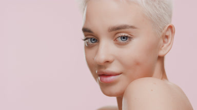 Young slim Caucasian woman turns head to the camera and smiling