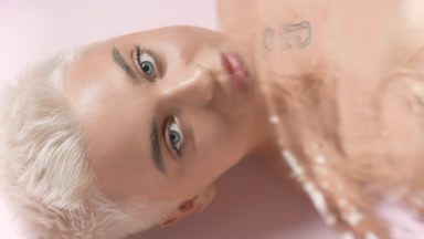 Gorgeous young slim Caucasian woman turns head and opens eyes