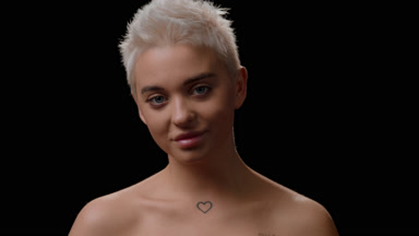 Gorgeous young Caucasian woman turns head to the camera smiling