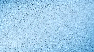 Medium size water drops blown off the glass surface on blue bg