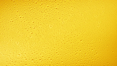 Medium size water drops blown off the glass surface on yellow bg