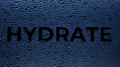 Blue hydrated word blown off the wet glass on black background