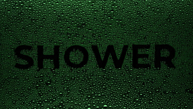 Green shower writing blown off the wet glass on black background