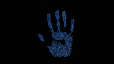 Blue inverted handprint blown off the wet glass on black bg