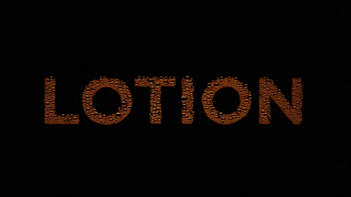Orange lotion text blown off the wet glass on black background