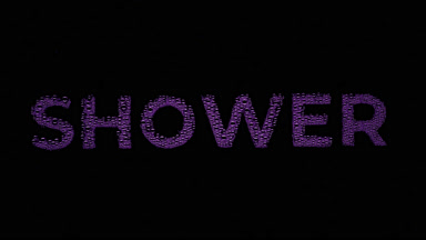 Purple shower word blown off the wet glass on black background