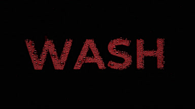 Red wash writing blown off the wet glass on black background