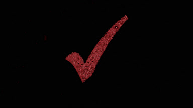Red checkmark blown off the wet glass on black background