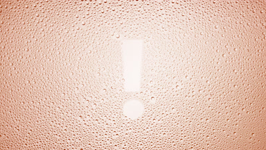 Exclamation sign blown off the wet glass on beige background