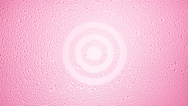 Target sign blown off the wet glass on pink background
