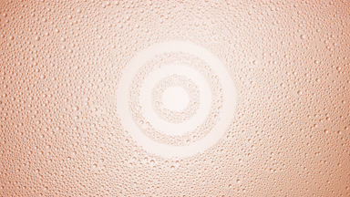 Target sign blown off the wet glass on beige background