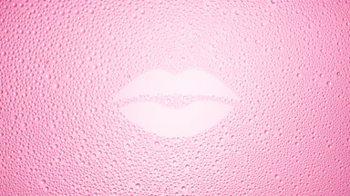 Lip shape print blown off the wet glass on pink background