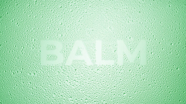 Balm writing blown off the wet glass on green background