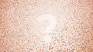 Question mark blown off the wet glass on beige background