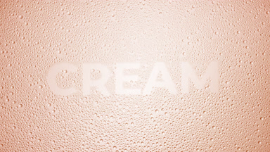 Cream word blown off the wet glass on beige background