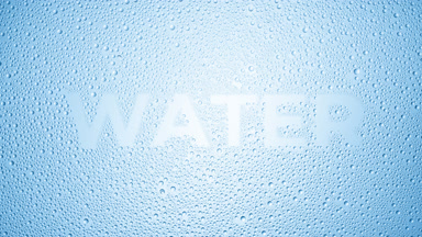 Water word blown off the wet glass on blue background