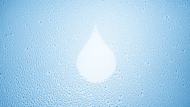 Drop shape print blown off the wet glass on blue background