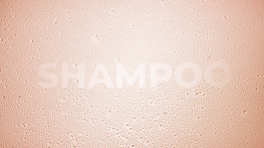 Shampoo word blown off the wet glass on beige background