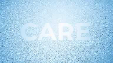 Care text blown off the wet glass on blue background