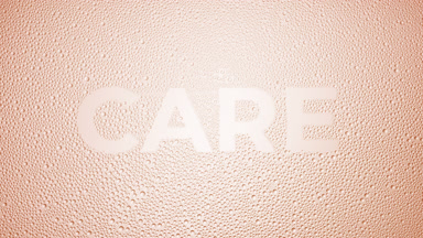 Care text blown off the wet glass on beige background
