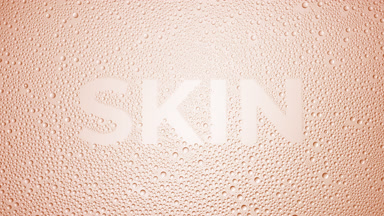 Skin word blown off the wet glass on beige background